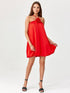 Model showcasing a bombshell cocktail dress with a floral detail in vibrant red fabric.