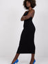 Model showcasing a summer pencil dress in black, featuring a fitted design and stylish blue heels, perfect for summer elegance.